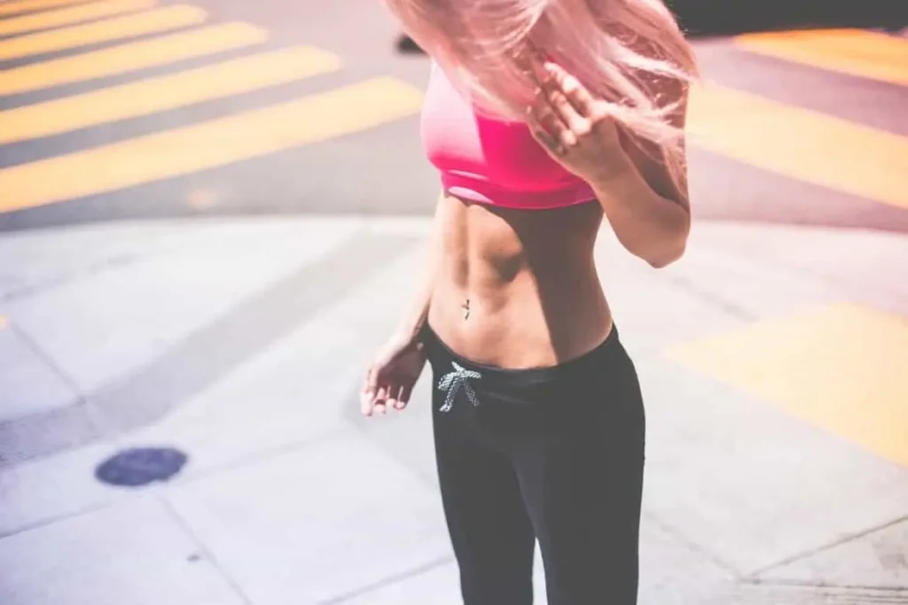 Woman with toned stomach after LA-EMS Body Sculpting Treatment Custom House